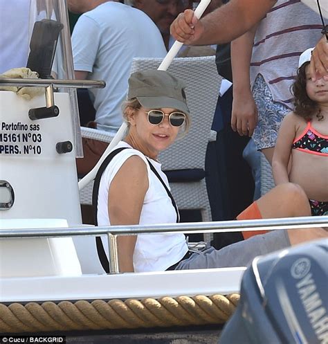 Meg Ryan makes a splash in the Mediterranean in tiny black。